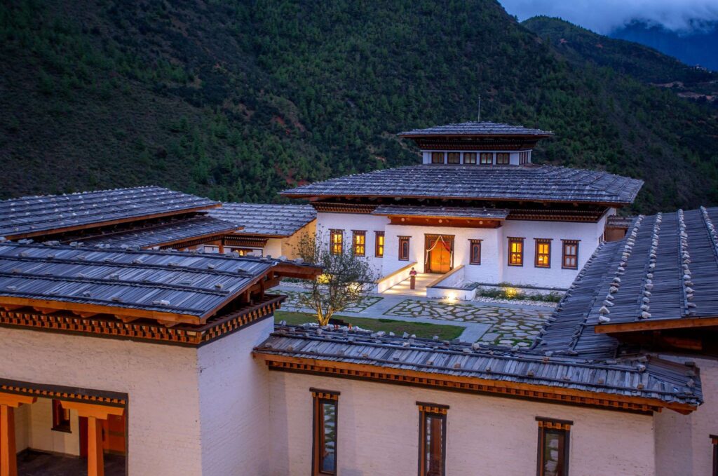 Bhutan spirit sanctuary building with a large courtyard and a hill in the background