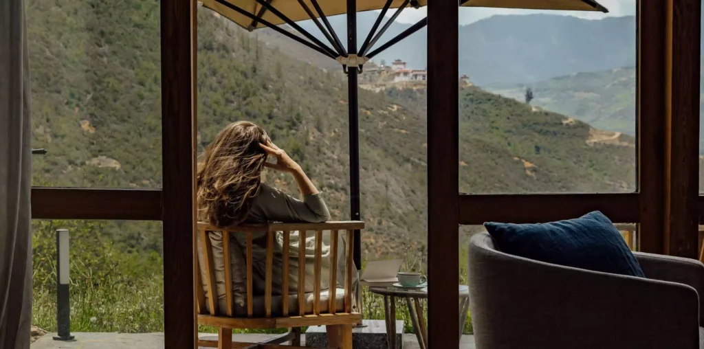 a woman sitting in a chair outside