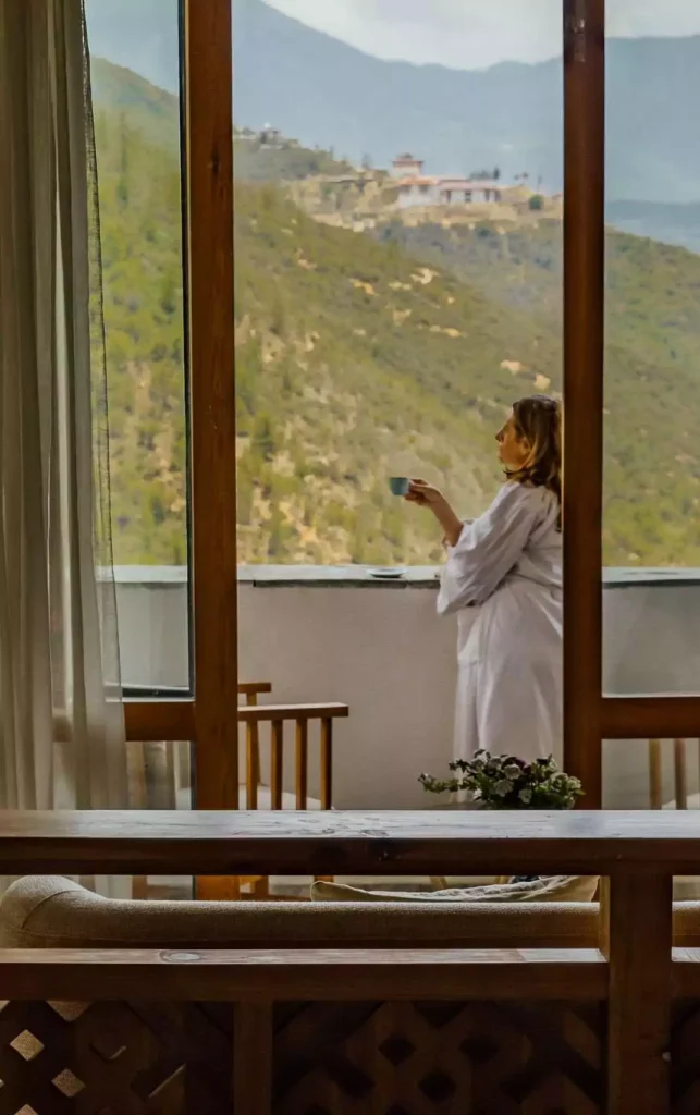 a woman in a white robe holding a cup