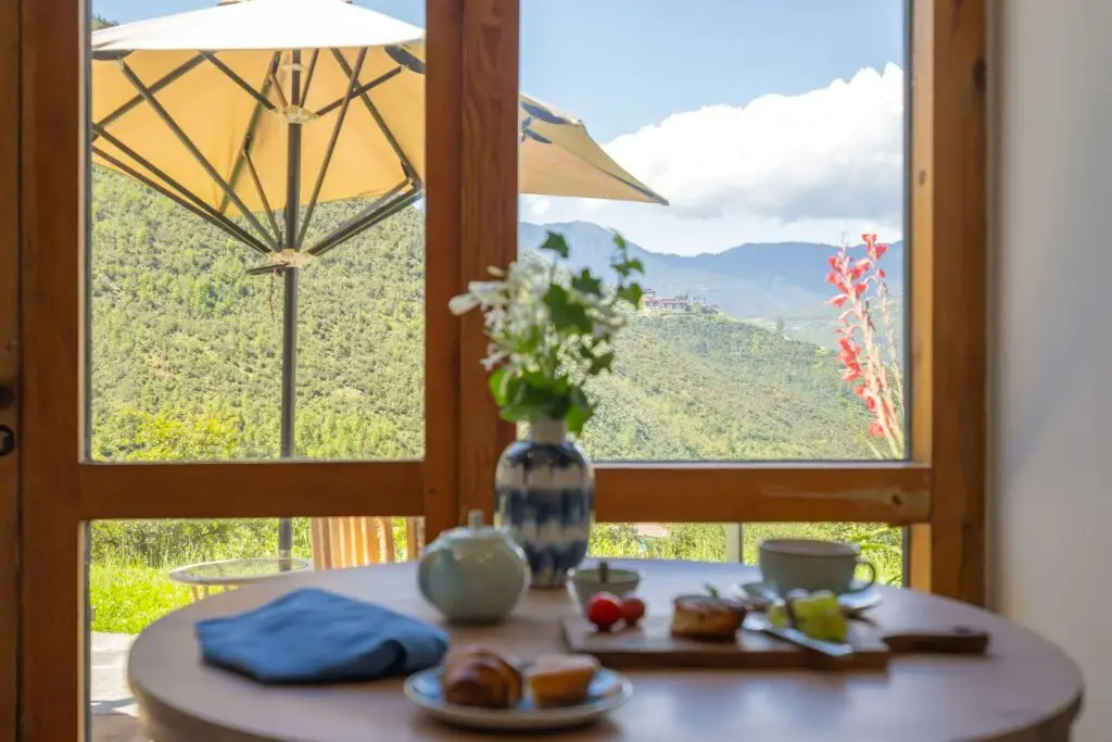 a table with food on it and a vase with flowers on it