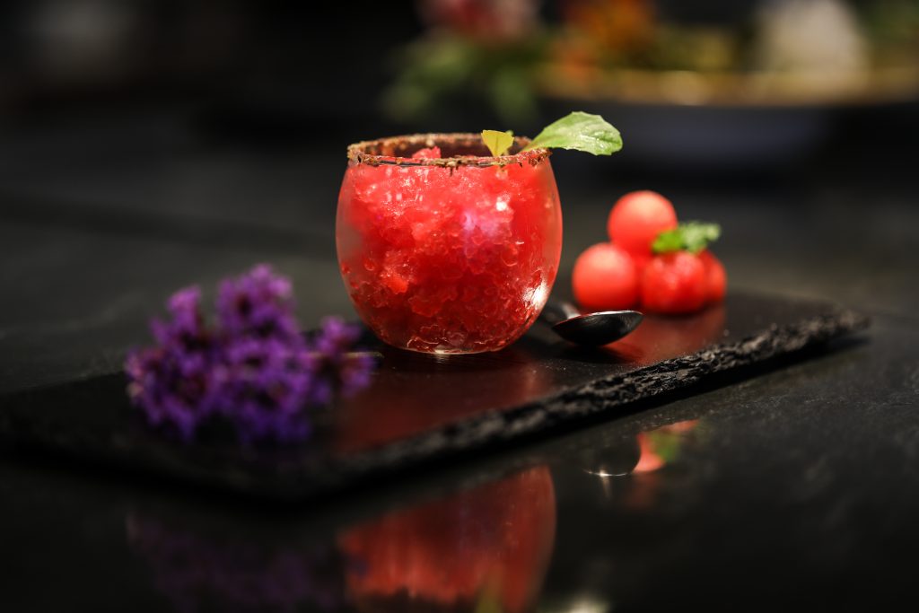 a glass with a drink and a spoon