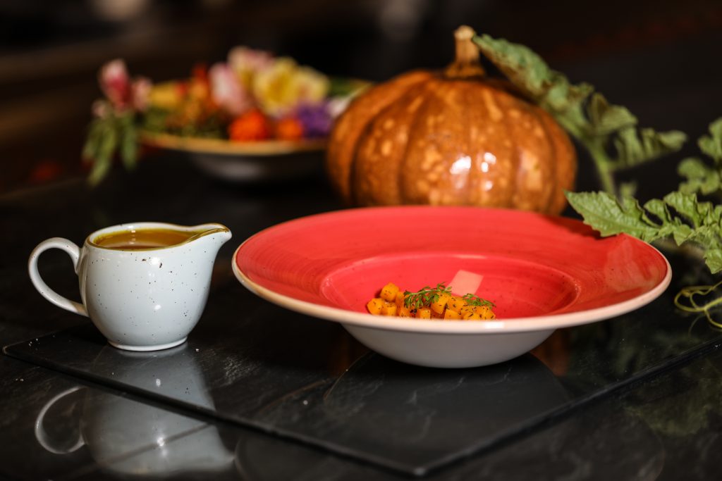 a plate of food and a saucer on a table