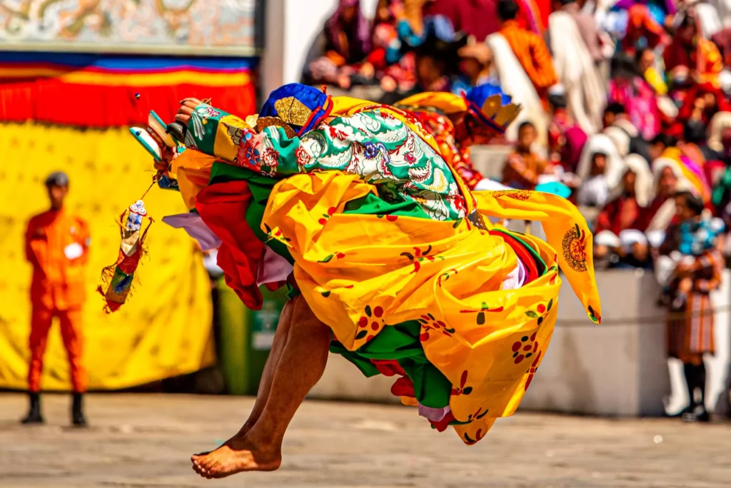 a person in a colorful robe jumping in the air