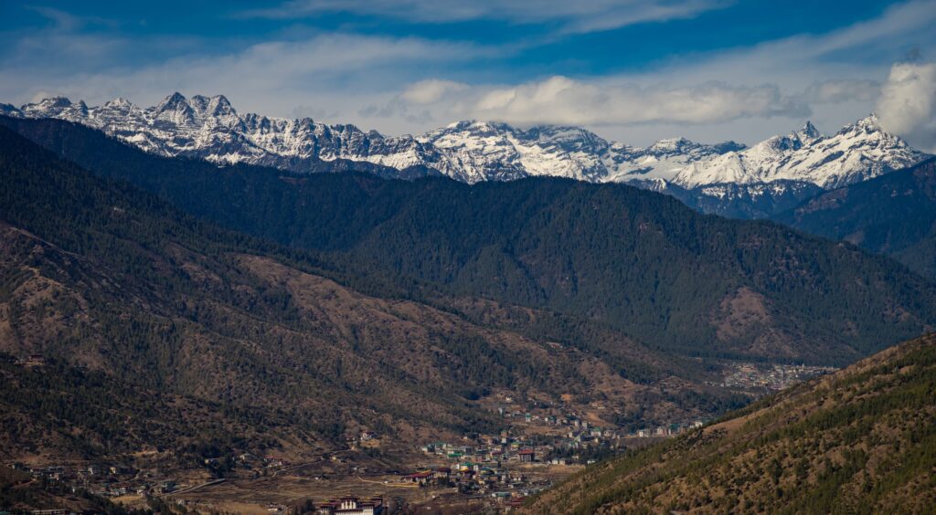 a town in a valley with mountains in the background