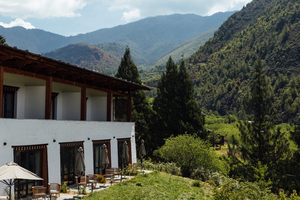 a building with chairs and trees in the background