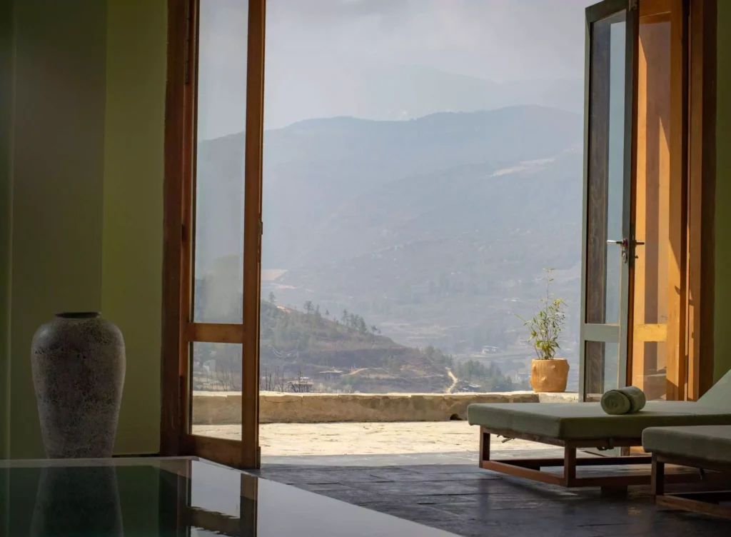 a room with a view of mountains and a couch