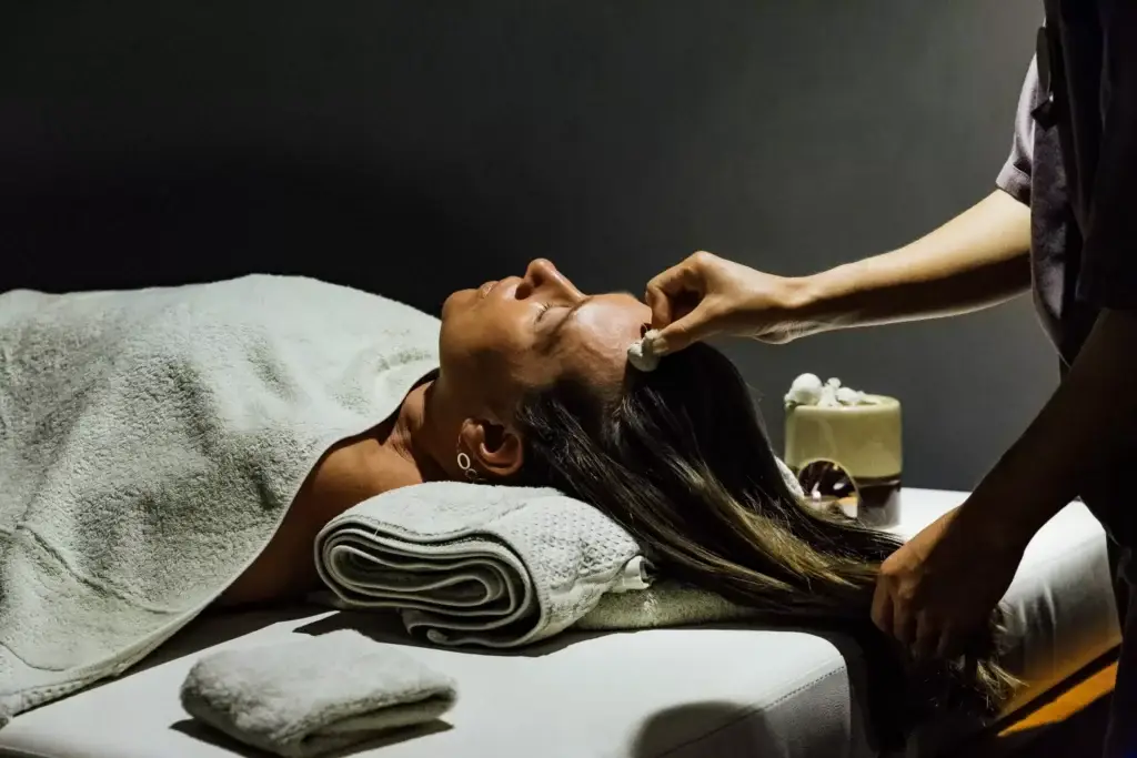 a person using a massage tool to a woman's head