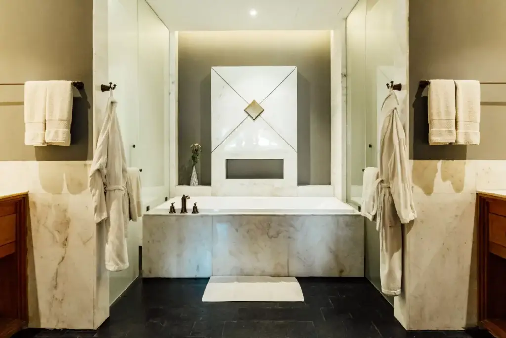 a bathroom with white towels on the wall