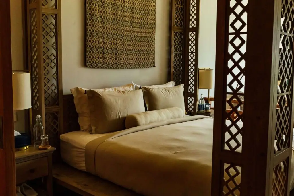 a bed with a pillow and a lamp