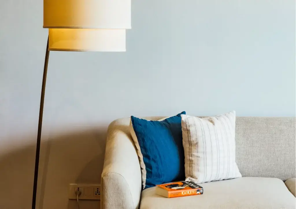 a lamp next to a couch