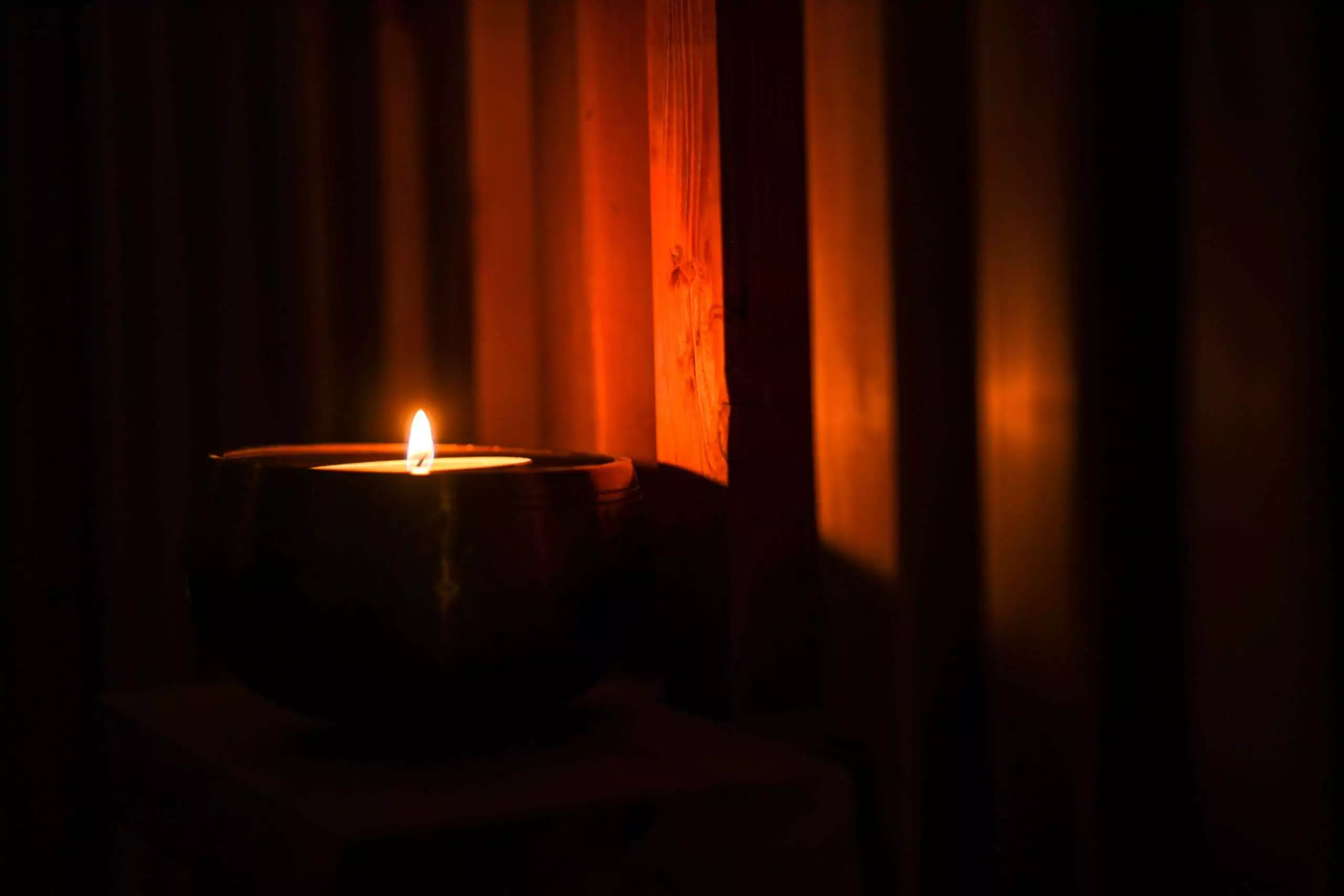 a candle in a dark room