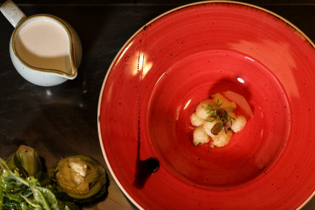 a red bowl with food in it